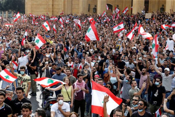 Demonstrators hold Lebanese flags as they gather during a protest over deteriorating economic situation, in Beirut, Lebanon October 18, 2019. REUTERS/Mohamed Azakir